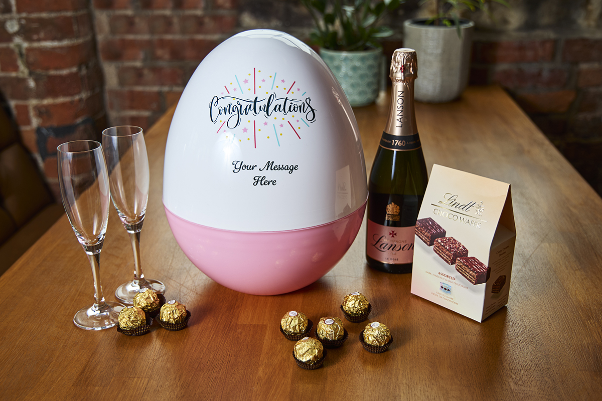 Giant plastic egg with champagne and chocolate. 